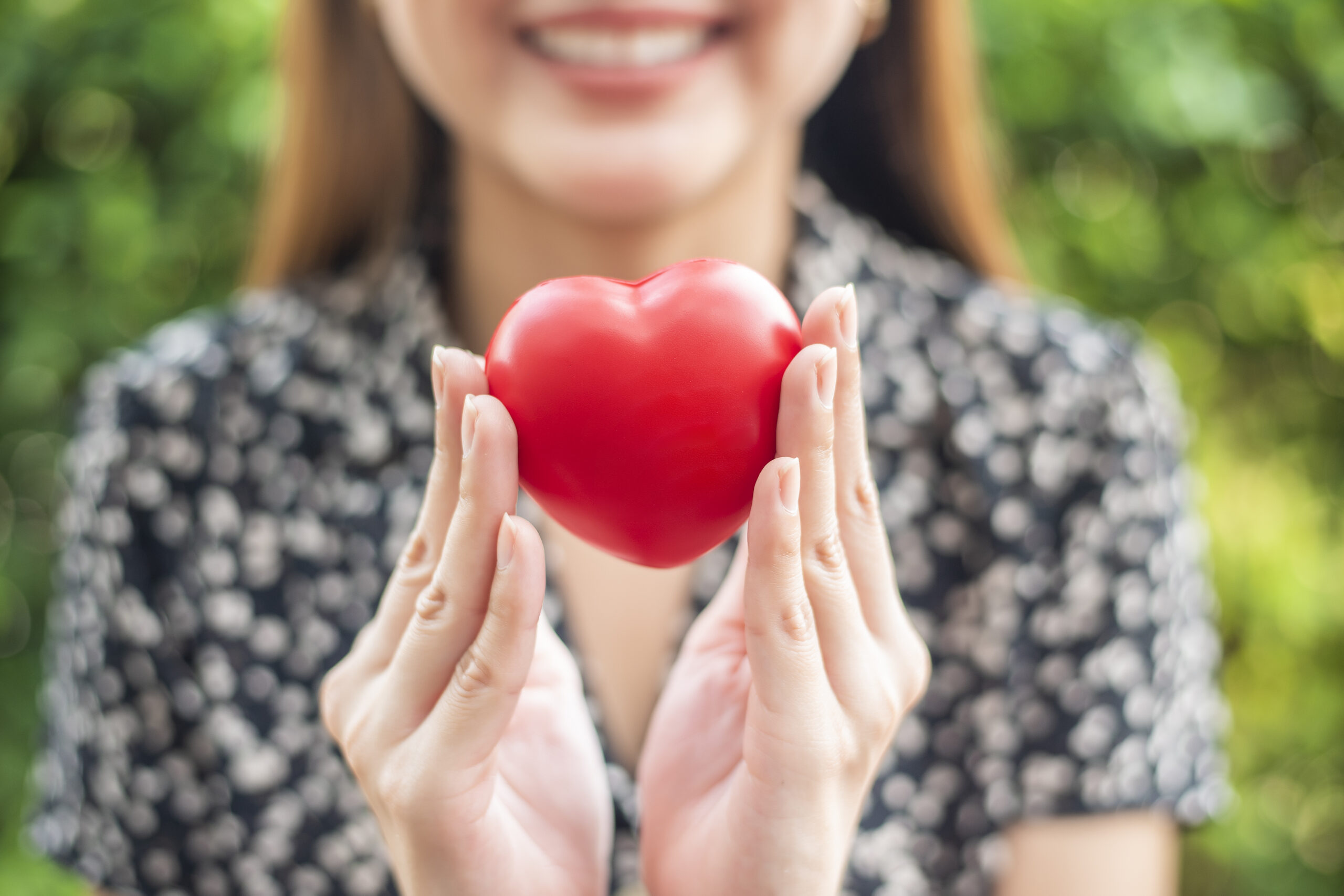 woman hand is holding red heart