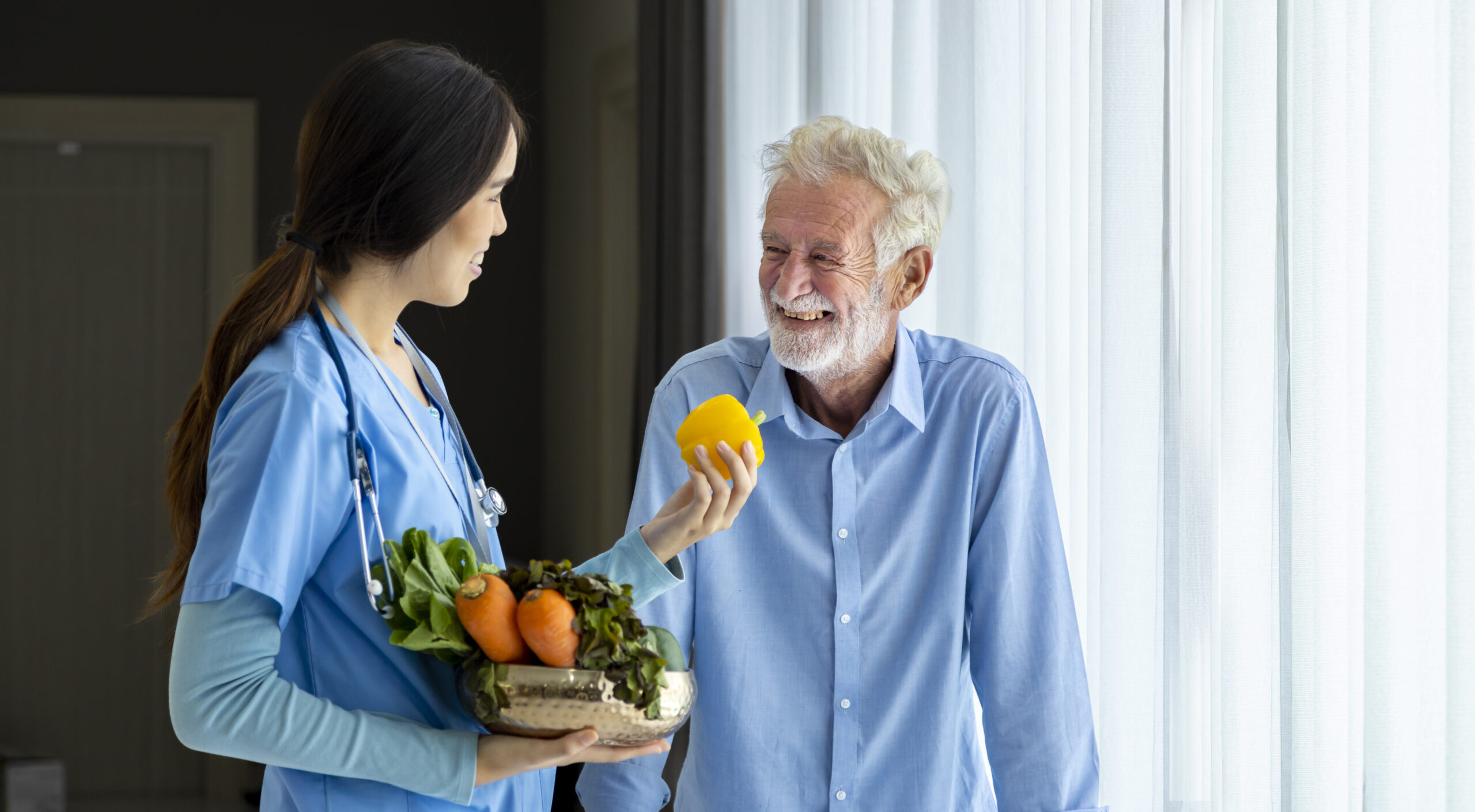 nurse and nutritionist is suggesting variety of vegetables to man
