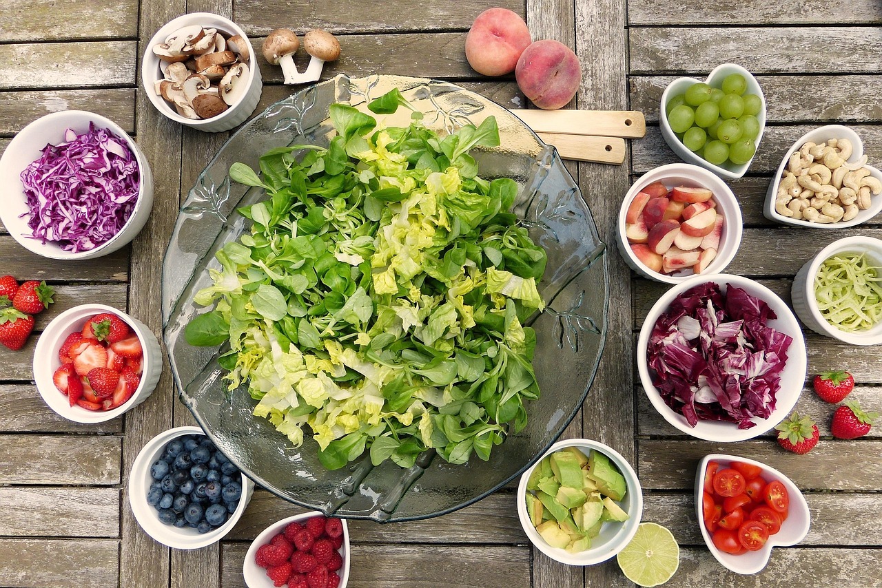 bowl of lettuce surrounded by toppings