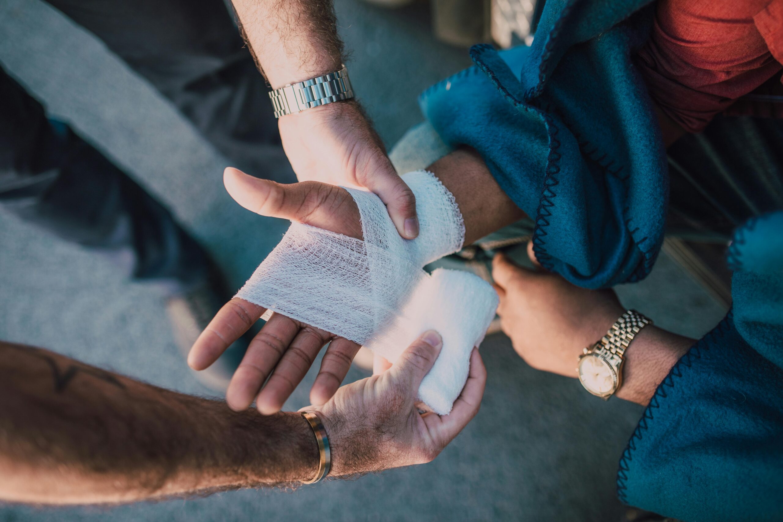 person getting hand wrapped in a bandage
