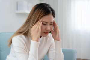 Headache, female having migraine pain