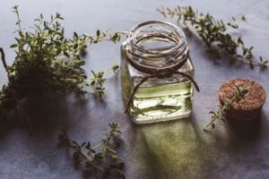 glass bottle of thyme essential oil