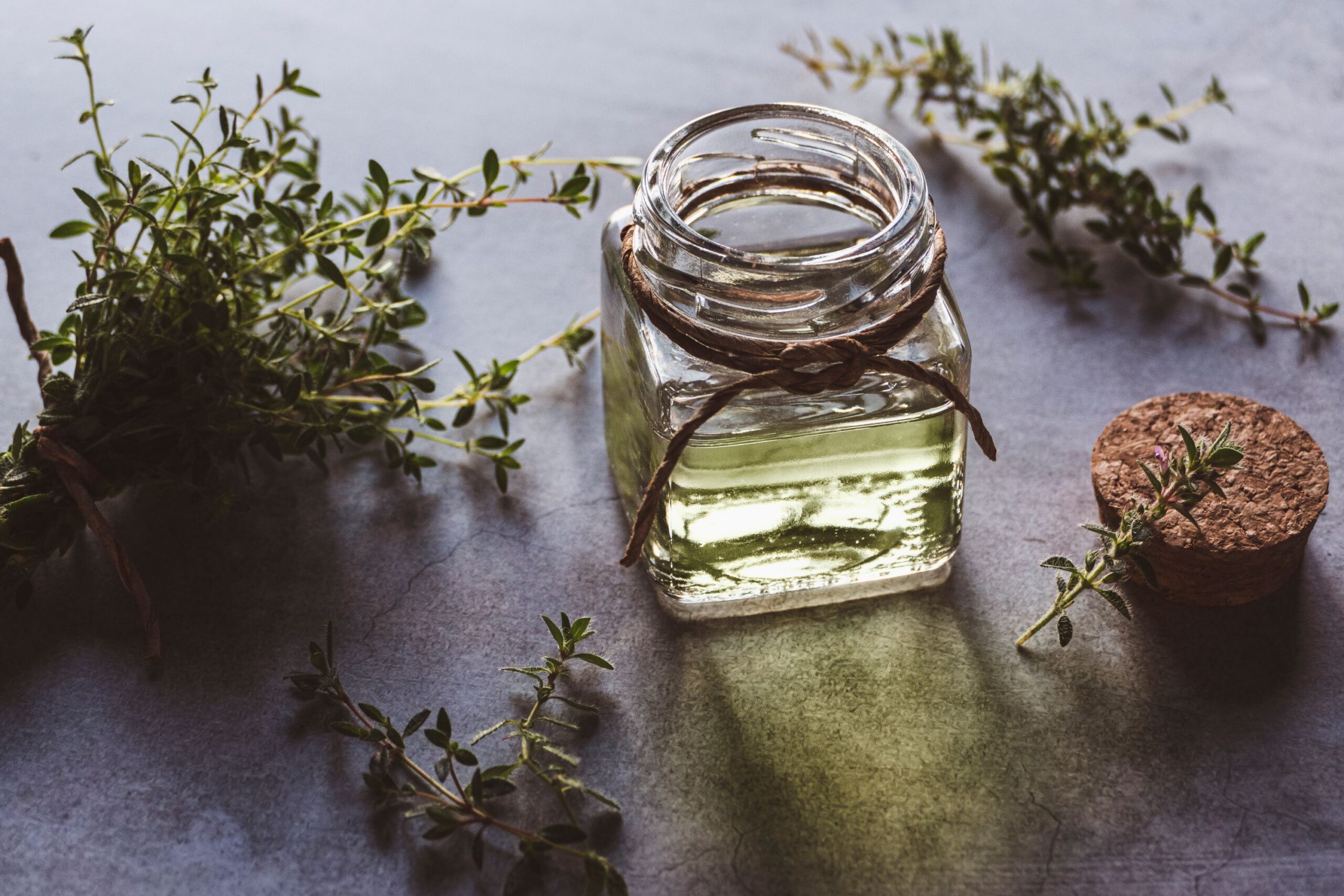 glass bottle of thyme essential oil