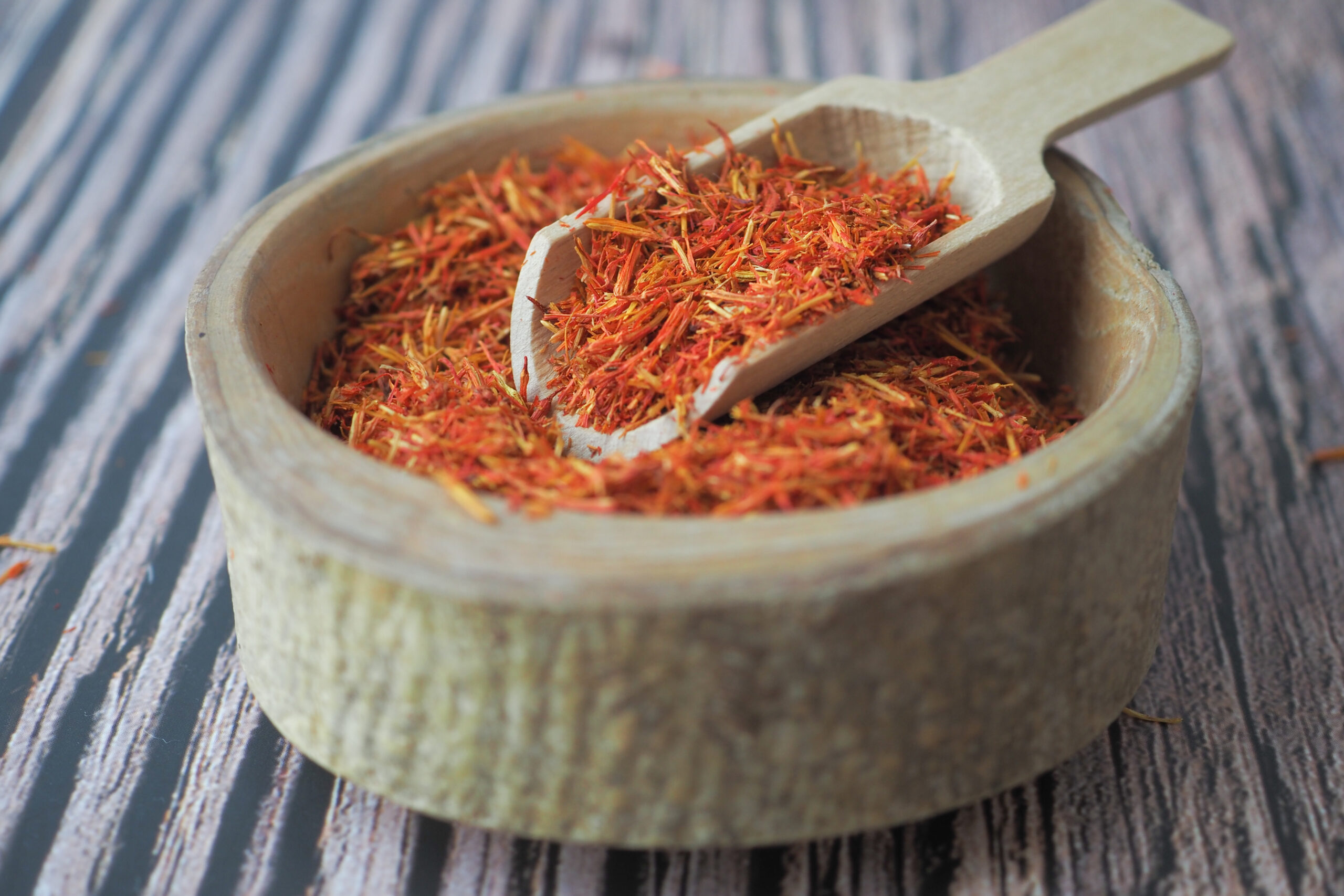 Saffron Spice in a wooden bowl on table